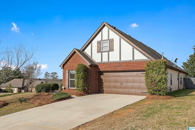 tudor-style house with brick siding, stucco siding, a garage, driveway, and a front lawn