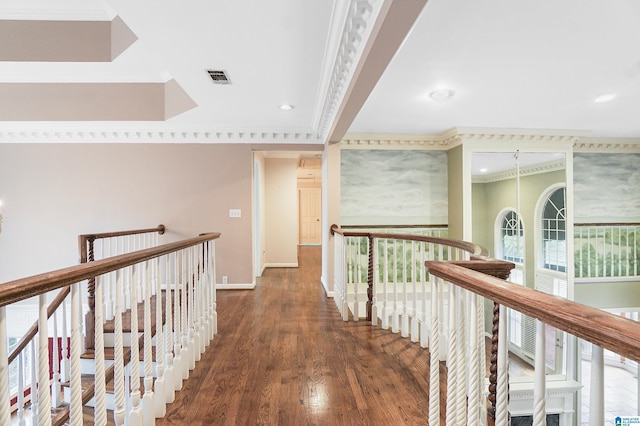 hall with visible vents, ornamental molding, an upstairs landing, wood finished floors, and baseboards