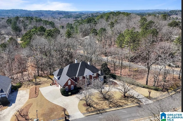 drone / aerial view featuring a forest view