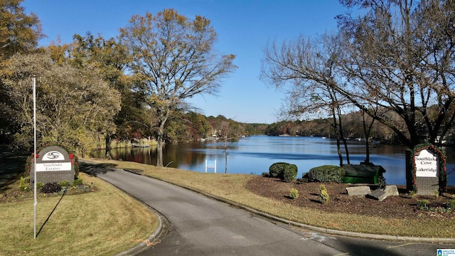 view of street featuring curbs and a water view