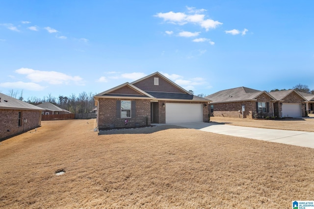 view of front of house featuring an attached garage, brick siding, fence, driveway, and a front lawn