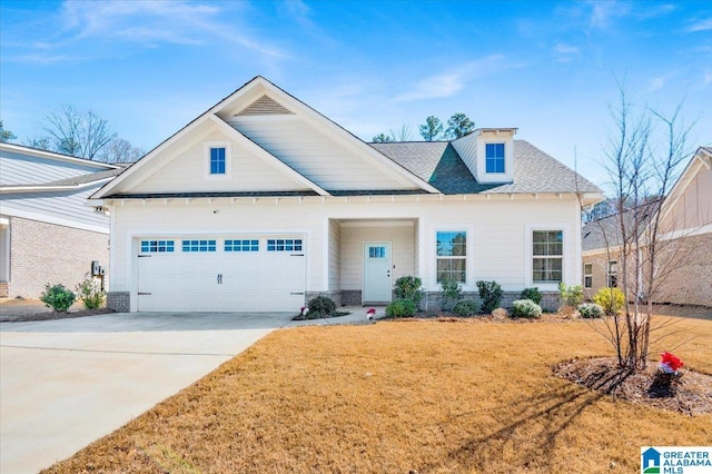 view of front of property with driveway, a shingled roof, a garage, and a front yard