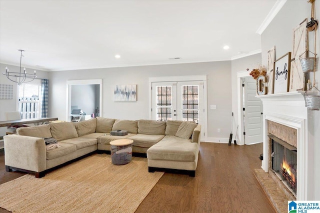 living area featuring recessed lighting, wood finished floors, a high end fireplace, ornamental molding, and french doors