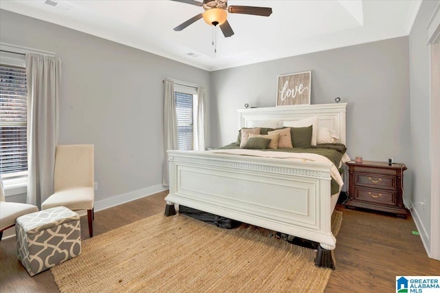 bedroom with ceiling fan, baseboards, and wood finished floors