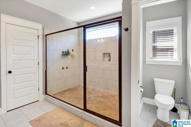 full bathroom featuring marble finish floor, toilet, a shower stall, and baseboards