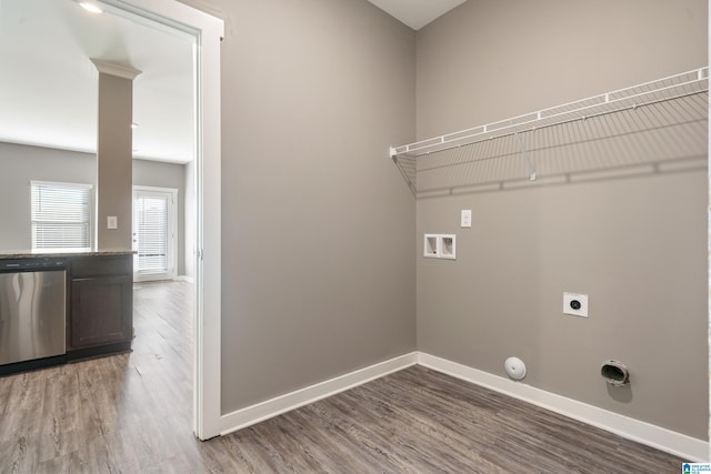 clothes washing area with hookup for an electric dryer, hookup for a gas dryer, washer hookup, wood finished floors, and baseboards