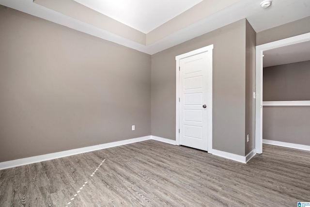 empty room with baseboards and wood finished floors