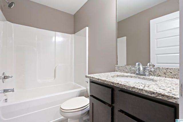 bathroom featuring bathing tub / shower combination, vanity, and toilet