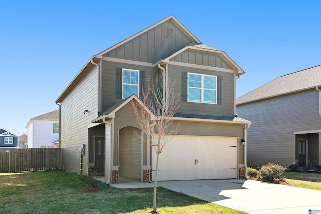 craftsman-style home with board and batten siding, fence, a garage, driveway, and a front lawn