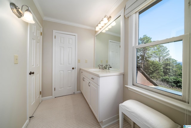 bathroom featuring baseboards, vanity, and crown molding