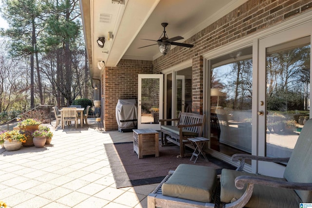 view of patio / terrace with outdoor dining area, a ceiling fan, and area for grilling