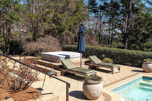 view of swimming pool featuring a patio area, a hot tub, fence, and a pool