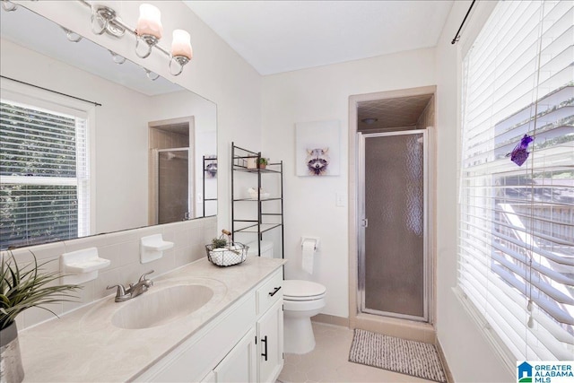 full bathroom featuring vanity, tile patterned flooring, a shower stall, and toilet