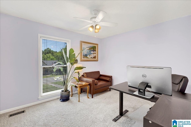 carpeted home office with ceiling fan, visible vents, and baseboards