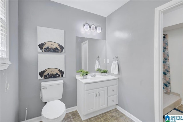 bathroom with a shower with shower curtain, vanity, toilet, and baseboards