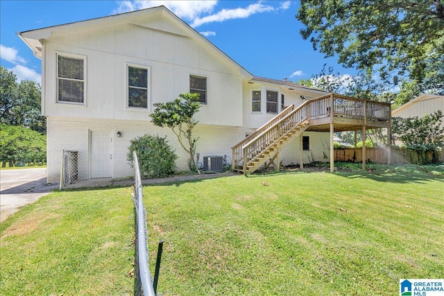 back of house with brick siding, a yard, stairway, and central AC unit