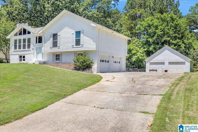 bi-level home featuring an outbuilding, a front yard, and a detached garage