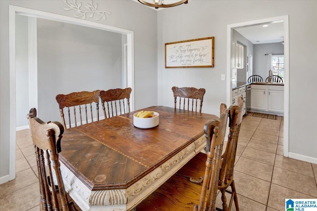 dining room featuring light tile patterned floors and baseboards