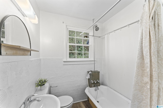 full bathroom with toilet, shower / bath combo, a sink, and wood finished floors