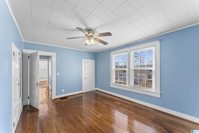 unfurnished bedroom featuring ornamental molding, hardwood / wood-style flooring, and baseboards