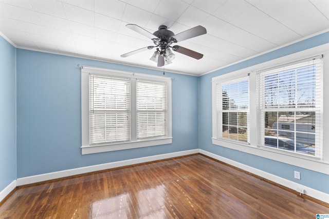 unfurnished room with hardwood / wood-style floors, crown molding, and a wealth of natural light