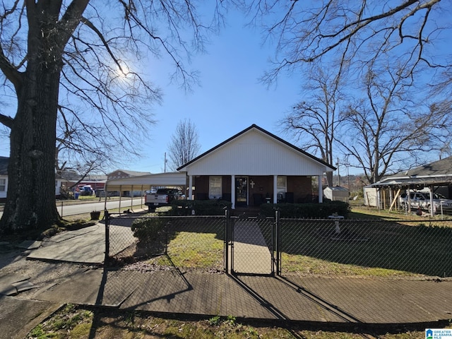 view of front facade with a fenced front yard, a gate, and a front yard