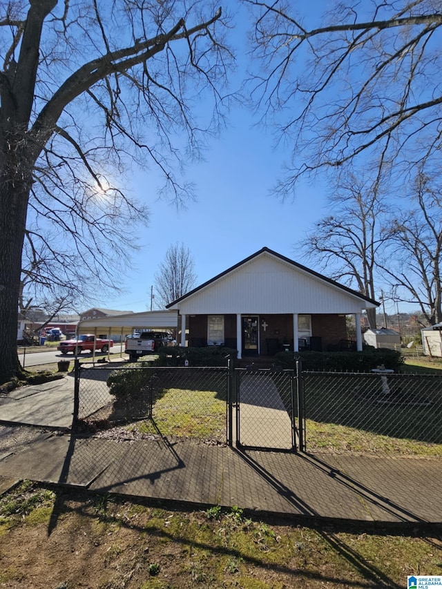 view of front of home with a fenced front yard and a gate