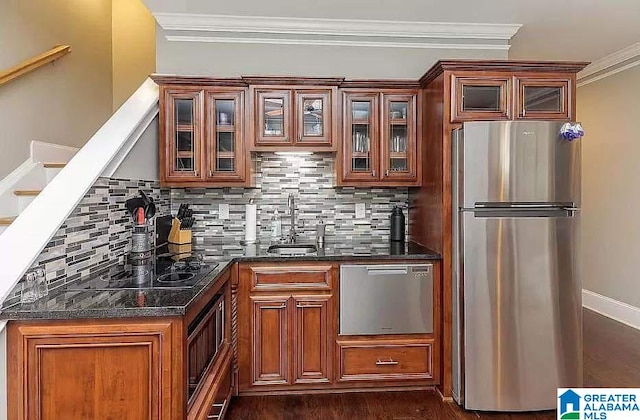 bar featuring stairway, freestanding refrigerator, wet bar, crown molding, and a sink