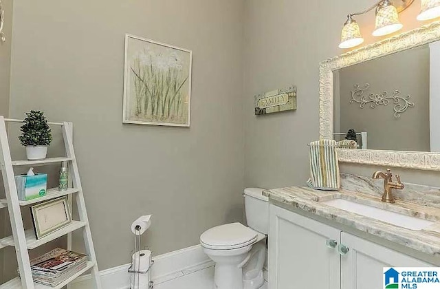 half bath featuring vanity, toilet, and baseboards