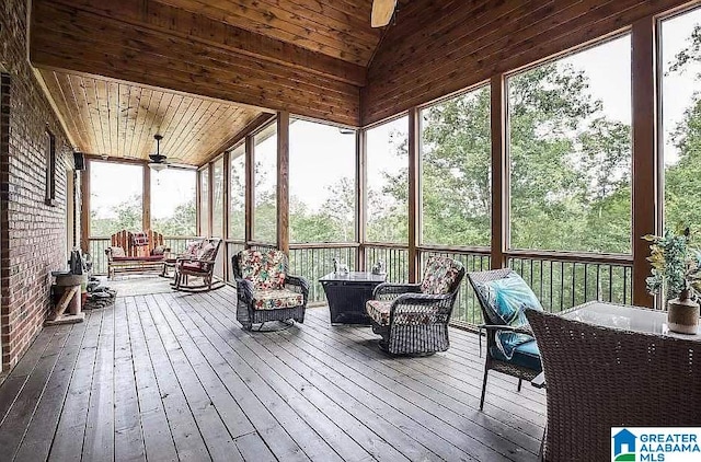 sunroom / solarium with ceiling fan, vaulted ceiling, and wooden ceiling