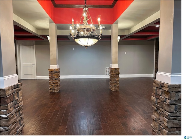 interior space featuring wood-type flooring, an inviting chandelier, and baseboards