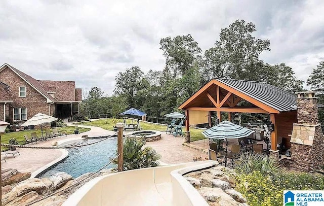 view of property's community featuring a patio area, a yard, and a gazebo