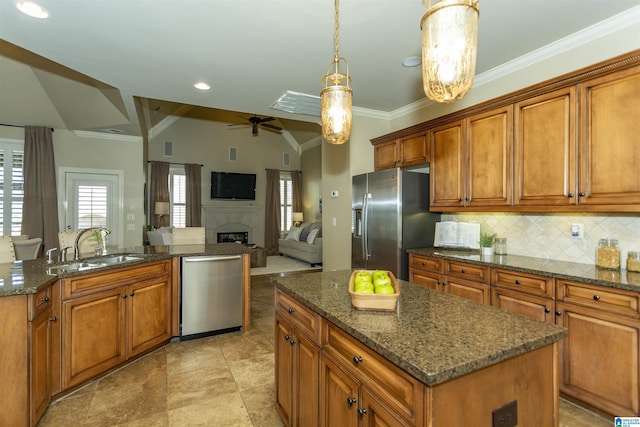 kitchen featuring appliances with stainless steel finishes, brown cabinetry, and a kitchen island