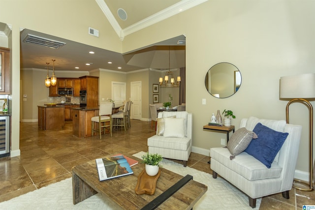 living area with a notable chandelier, baseboards, visible vents, and crown molding