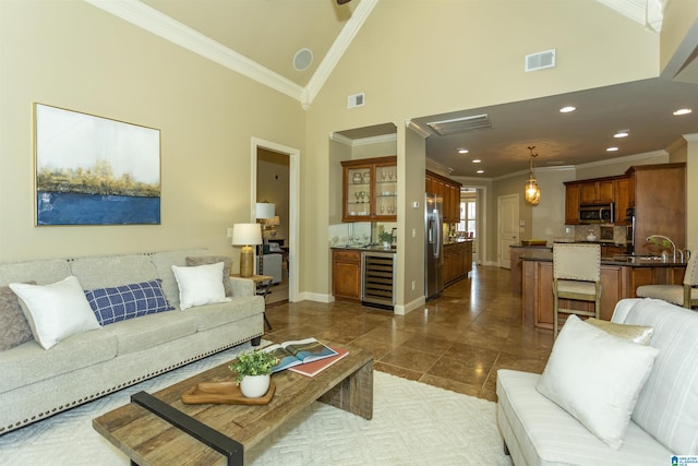 living room featuring wine cooler, indoor bar, visible vents, and crown molding