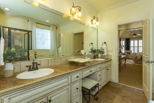 ensuite bathroom with ornamental molding, a sink, and double vanity