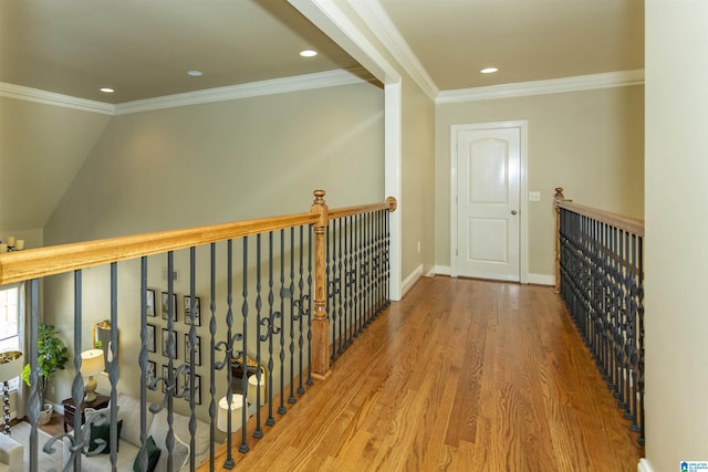 corridor with baseboards, recessed lighting, wood finished floors, and crown molding