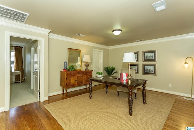 office area with ornamental molding, dark wood finished floors, and visible vents