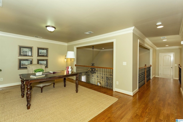 home office featuring ornamental molding, visible vents, baseboards, and wood finished floors