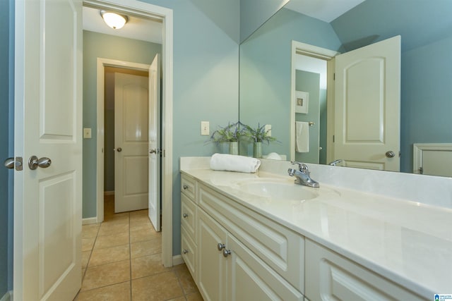 bathroom with tile patterned flooring, vanity, and baseboards