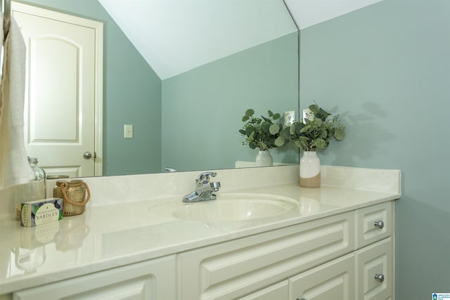 bathroom featuring vaulted ceiling and vanity