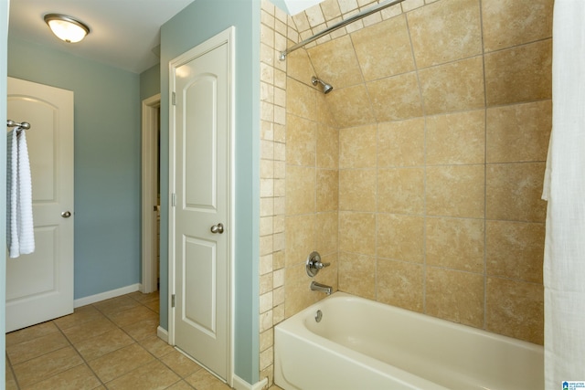 bathroom with washtub / shower combination, baseboards, and tile patterned floors