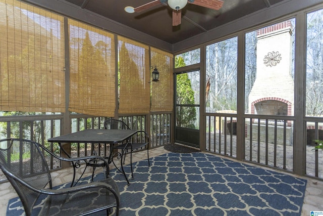 sunroom / solarium with a ceiling fan