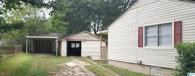 view of side of property featuring a yard, crawl space, fence, and an outdoor structure