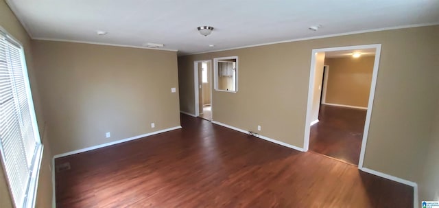 unfurnished room with baseboards, wood finished floors, and crown molding