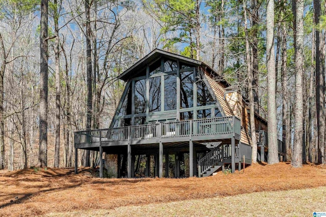 rear view of house featuring stairs and a deck