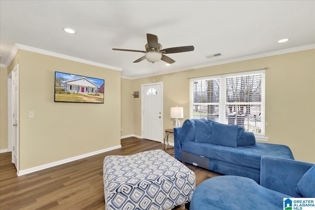 living area with ornamental molding, dark wood-style flooring, and baseboards