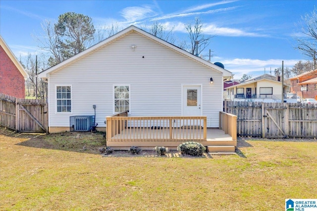 back of house featuring a wooden deck, fence, central AC, and a yard