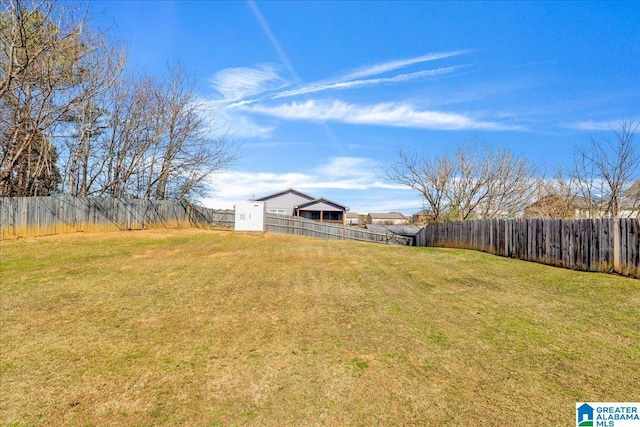 view of yard with a fenced backyard