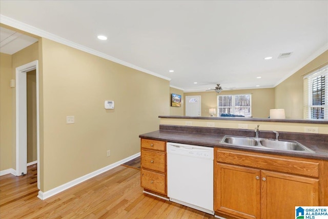 kitchen with light wood-style floors, white dishwasher, a sink, and crown molding